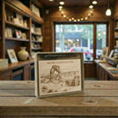 Gift set with Arches National Park illustration on a wooden plaque inside a store.