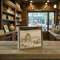 Gift set with Arches National Park illustration on a wooden plaque inside a store.