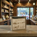 Wooden box with 'Great Smoky Mountains' design on a wooden table in a store setting.