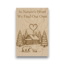 Wooden plaque with engraved illustration of a cabin, trees, and bears, along with the text 'In Nature's Heart We Find Our Own'.