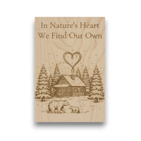 Wooden plaque with engraved illustration of a cabin, trees, and bears, along with the text 'In Nature's Heart We Find Our Own'.