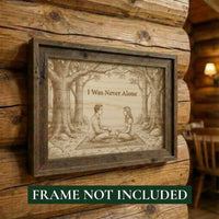Wooden plaque with engraved couple in a forest scene and 'I Was Never Alone' text, mounted on a wooden wall.