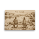 Engraved wooden plaque with a couple sitting on a bench by a lake, text 'You Stayed' above them.