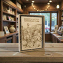 Framed Bryce Canyon National Park print on a wooden table with a blurred indoor background