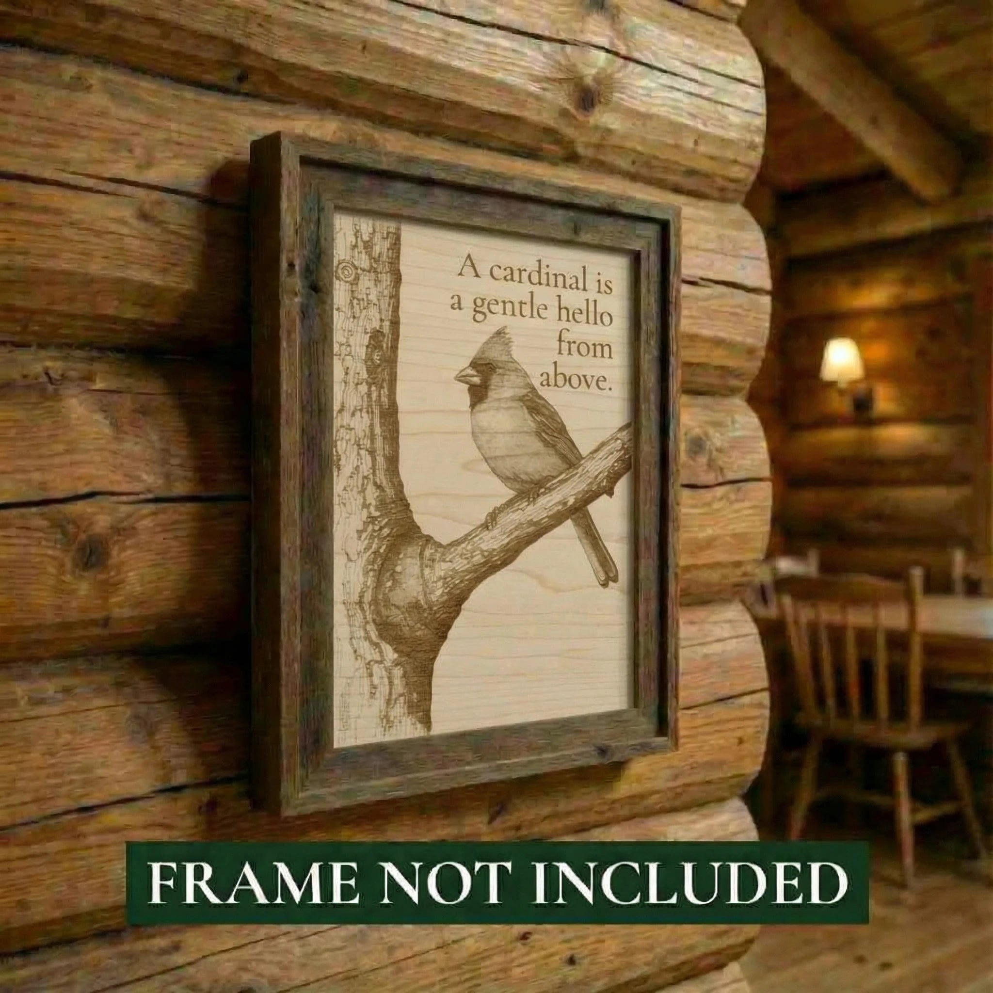 Framed artwork of a cardinal on a branch with a quote, mounted on a wooden wall.