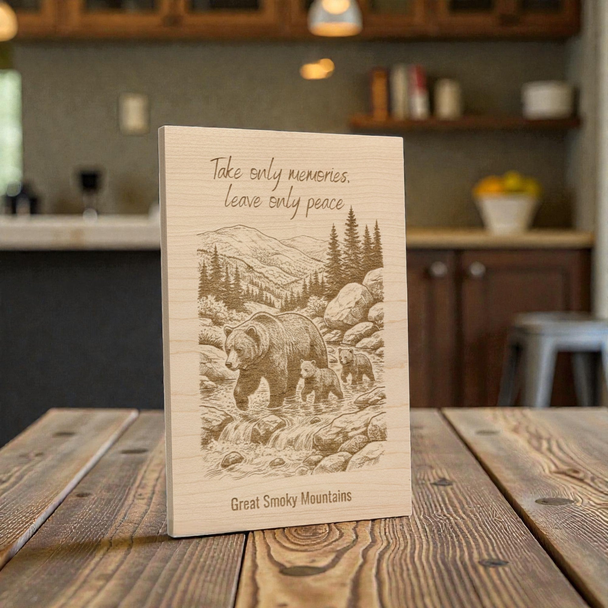 Wooden plaque with bear illustration and text on a wooden table in a kitchen setting