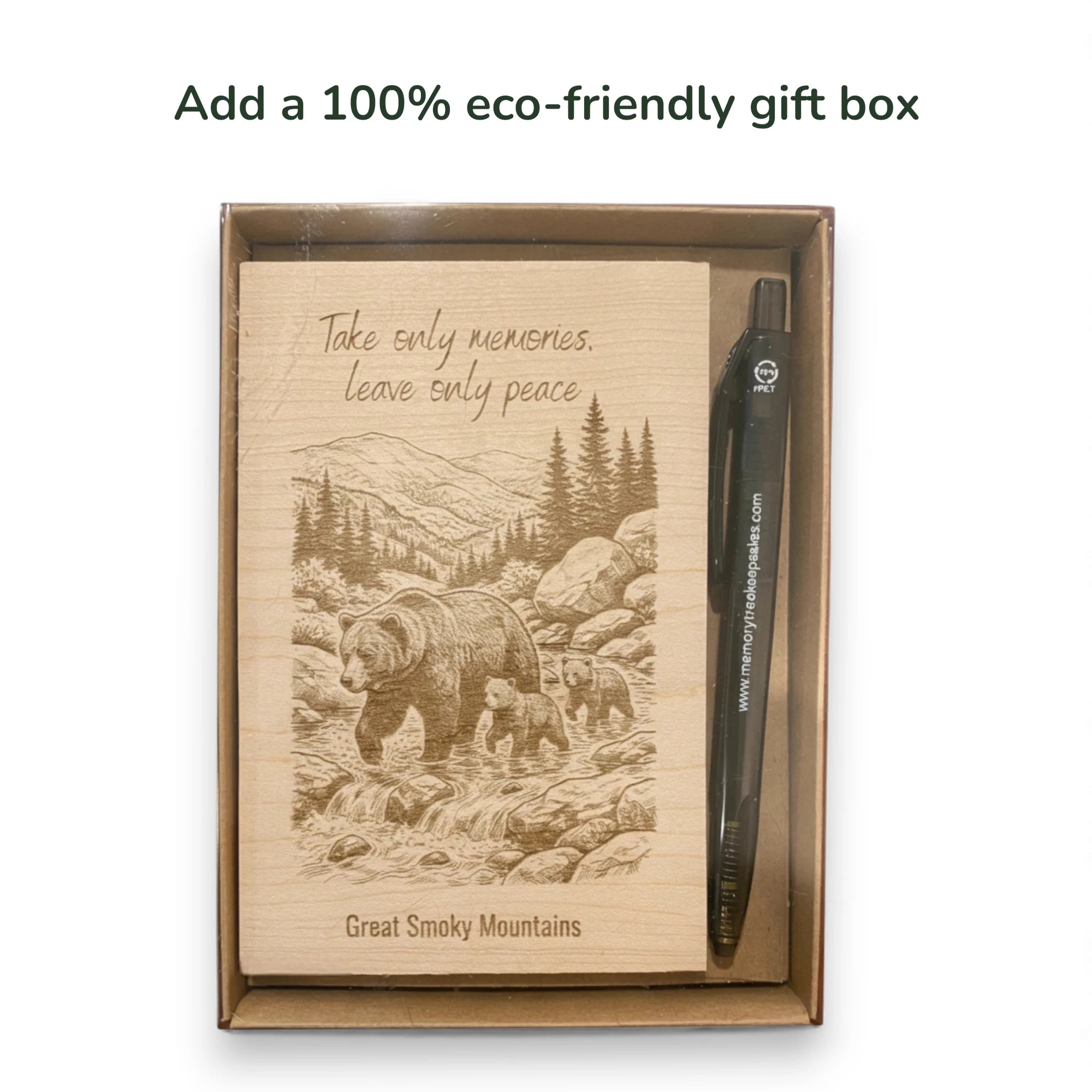 Eco-friendly gift box with a wooden insert featuring a bear illustration and text, accompanied by a pen.