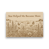 Wooden plaque with nature design and engraved text 'You Helped Me Become More' on a white background