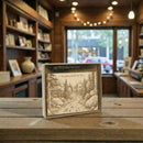 Wooden box with engraved design on a wooden table in a cozy indoor setting.
