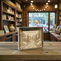 Wooden box with engraved design on a wooden table in a cozy indoor setting.